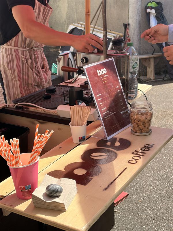 La carte des boissons Boé Coffee posée sur le comptoir du triporteur, avec le sucre roux et les pailles